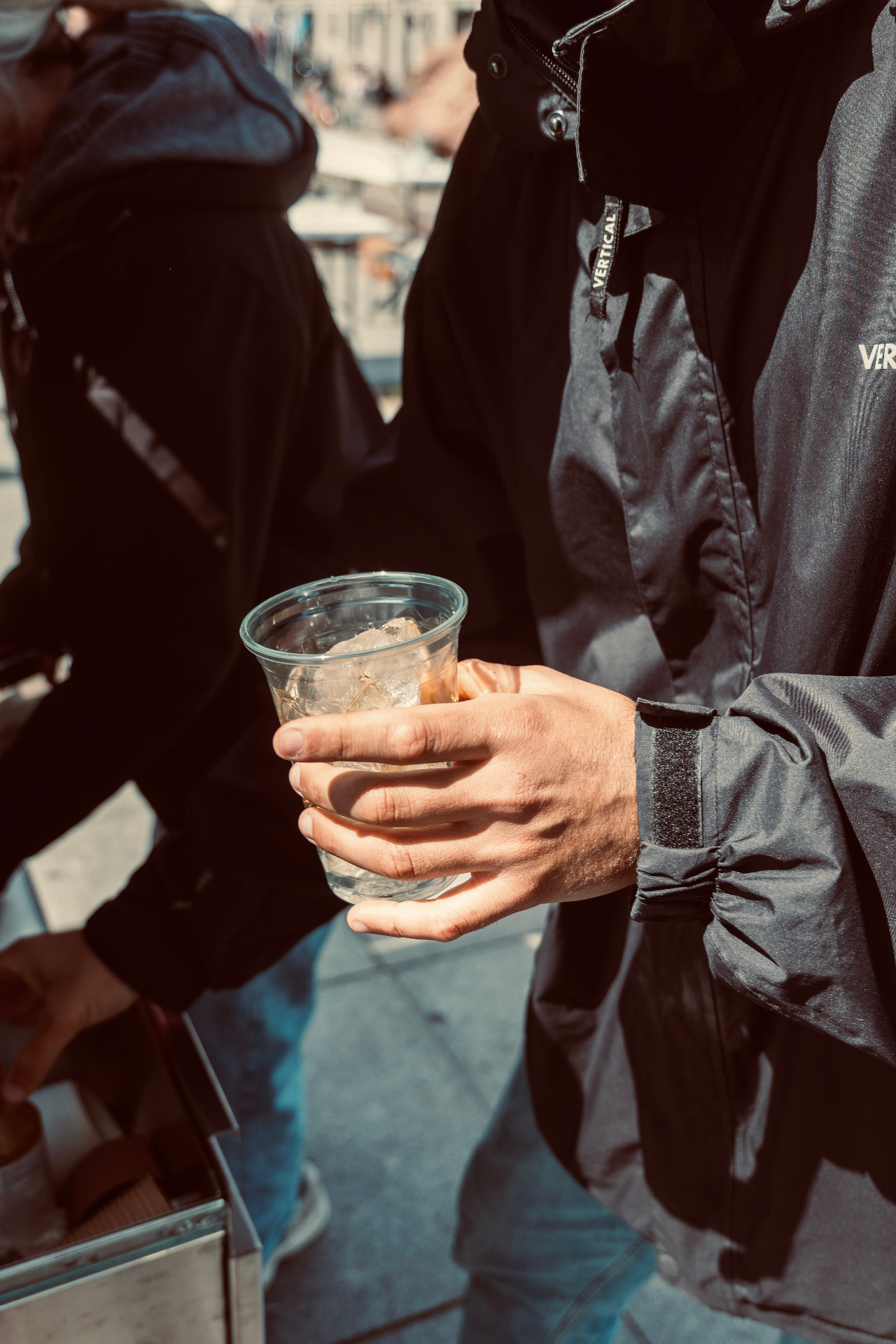 Guest holding an iced coffee outside the van