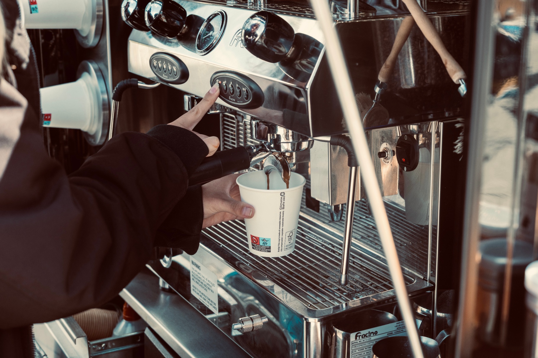 Espresso being pulled into a paper cup